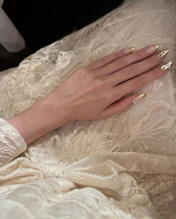 Liquid Luxury  Champagne Drape press-on nail kit contents — adhesive tabs, file and cuticle pusher | GlossyMuse