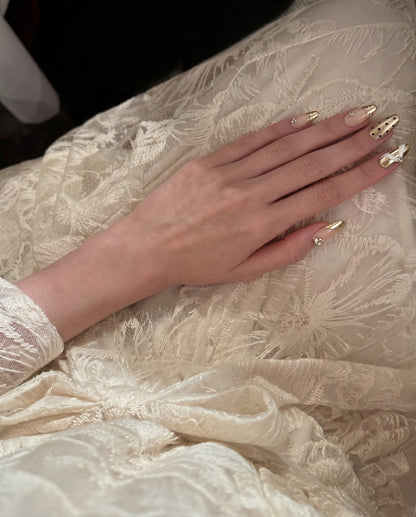 Liquid Luxury  Champagne Drape press-on nail kit contents — adhesive tabs, file and cuticle pusher | GlossyMuse