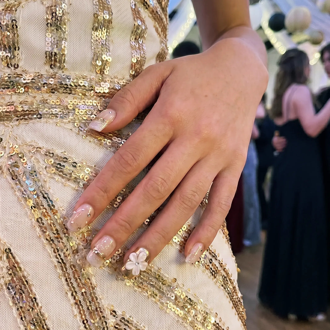 Model wearing Floral Bliss  Daisy Glow square short press-on nails — lifestyle close-up | GlossyMuse