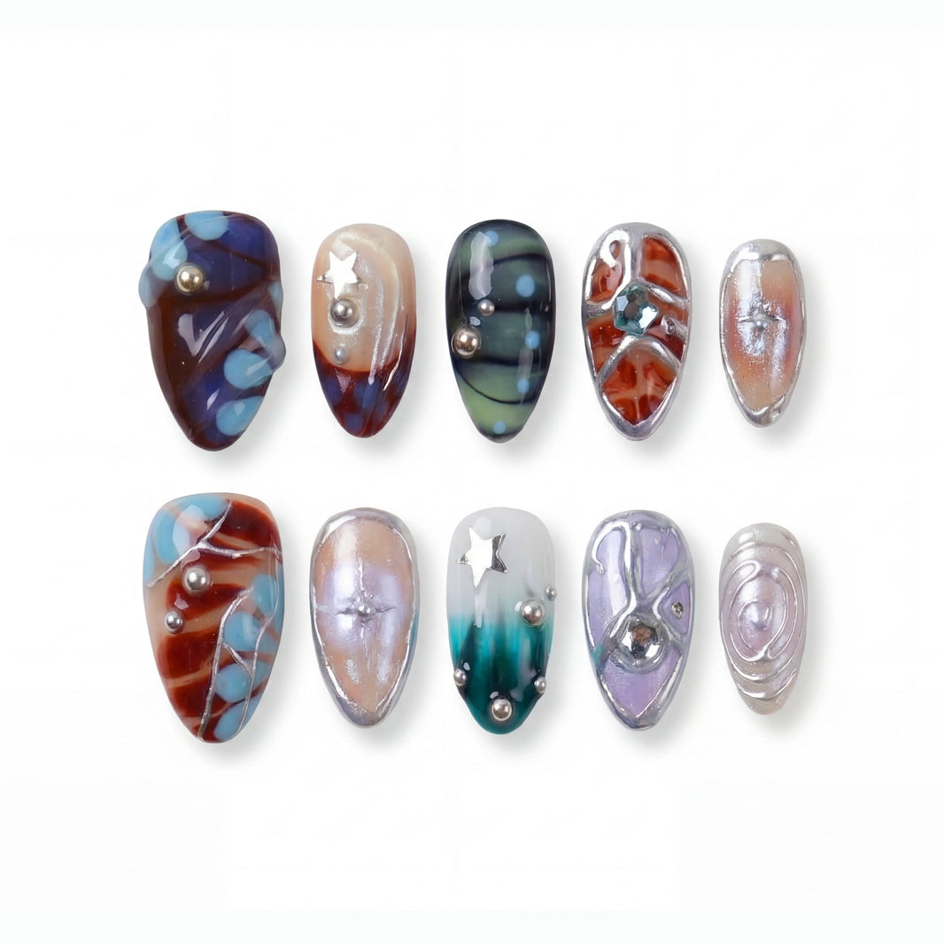 Ten colorful nail designs with various patterns and embellishments, including stars and pearls.