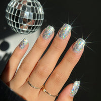 Model wearing Disco Spark Cubes almond press-on nails — lifestyle close-up | GlossyMuse