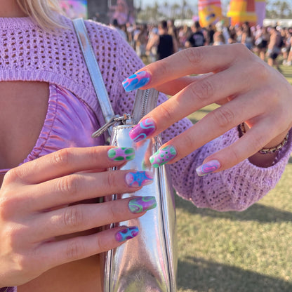 Ten colorful nail art designs in shades of blue, pink, green, and purple with abstract patterns.