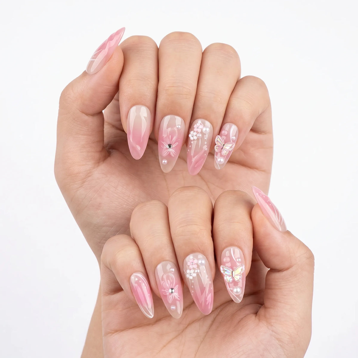 Garden of Forever pink ombre nail art with iridescent butterfly charm, 3D floral designs, pearl and rhinestone accents on almond shaped nails