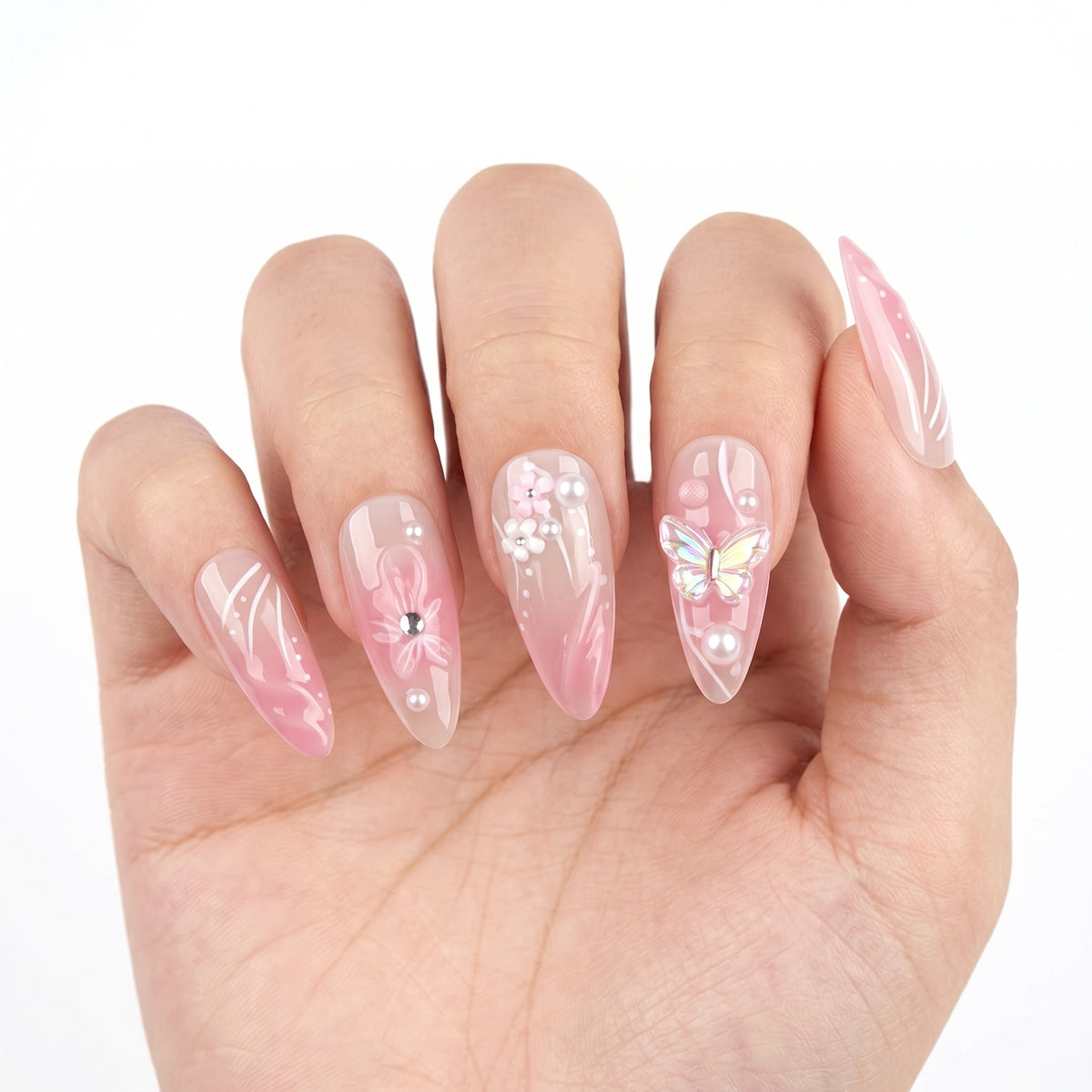 Garden of Forever pink sheer nail art with holographic butterfly 3D charm, floral embellishments and pearl details on stiletto almond nails
