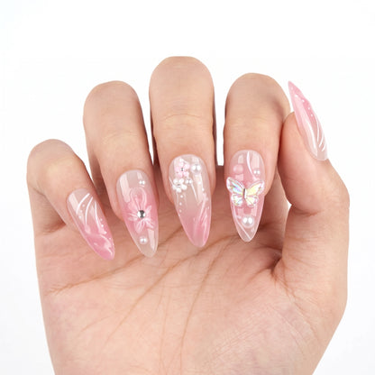 Garden of Forever pink sheer nail art with holographic butterfly 3D charm, floral embellishments and pearl details on stiletto almond nails