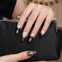 Model wearing Dark Romance  Glazed Noir Bow almond press-on nails — lifestyle close-up | GlossyMuse