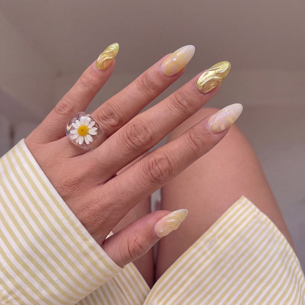 Model wearing Golden Sprinkle Fizz almond press-on nails — lifestyle close-up | GlossyMuse