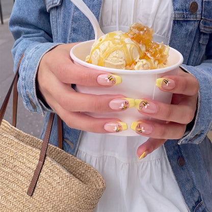 Model wearing Honey Gin Fizz almond press-on nails — lifestyle close-up | GlossyMuse