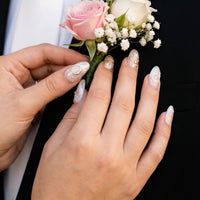 Model wearing Celestial Luxe  Ivory Gold Orbit almond press-on nails — lifestyle close-up | GlossyMuse