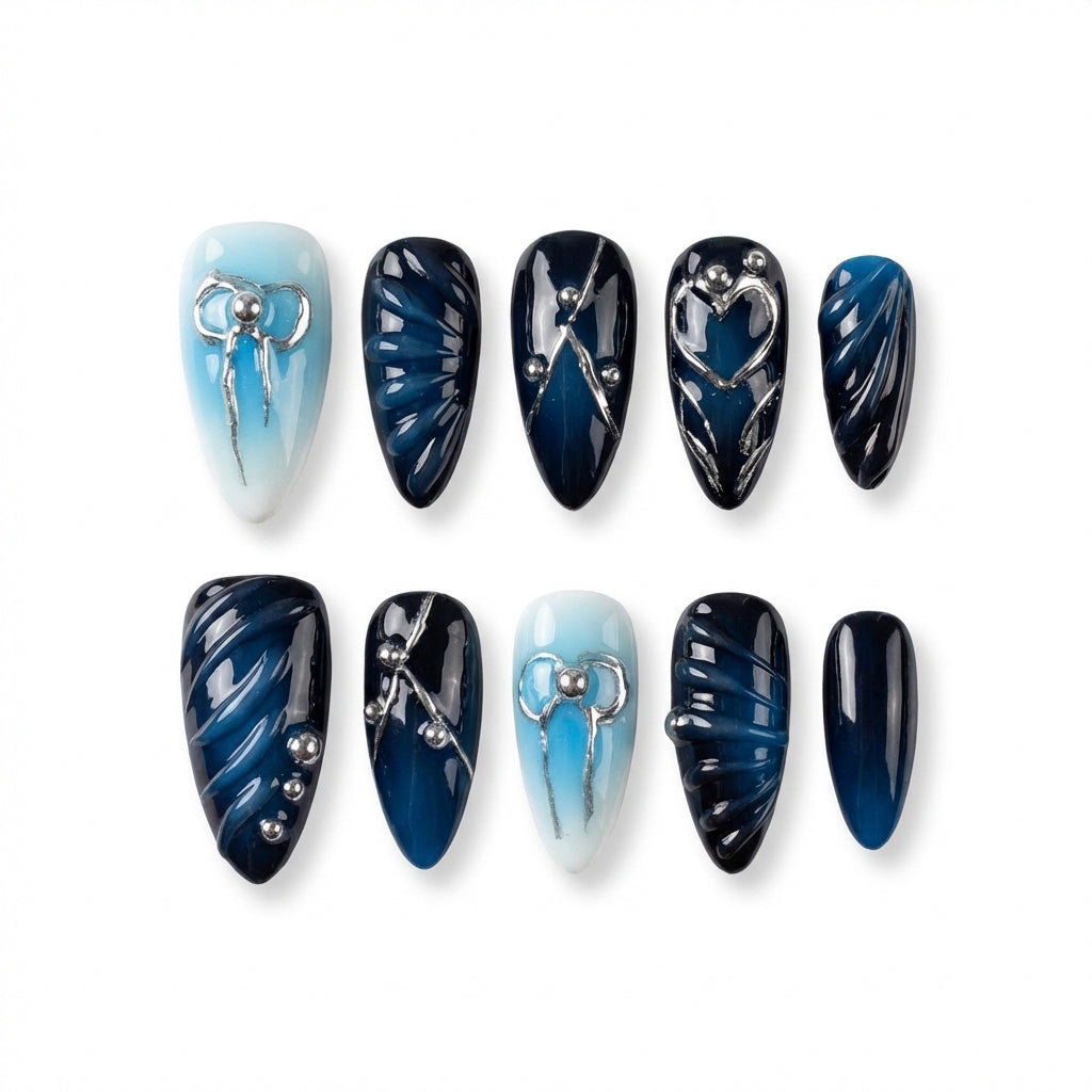 Ten almond nail art designs in blue and navy colors, featuring patterns and silver accents.