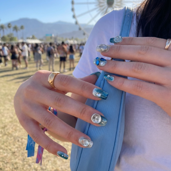 short square nail art design with blue and silver decorations, featuring flowers, pearls, and shiny elements.