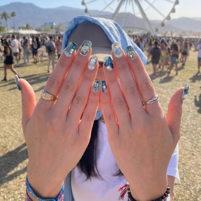 short square nail art design with blue and silver decorations, featuring flowers, pearls, and shiny elements.