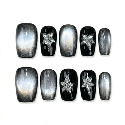 square nail art set with black and silver cat-eye designs, featuring star-shaped embellishments.