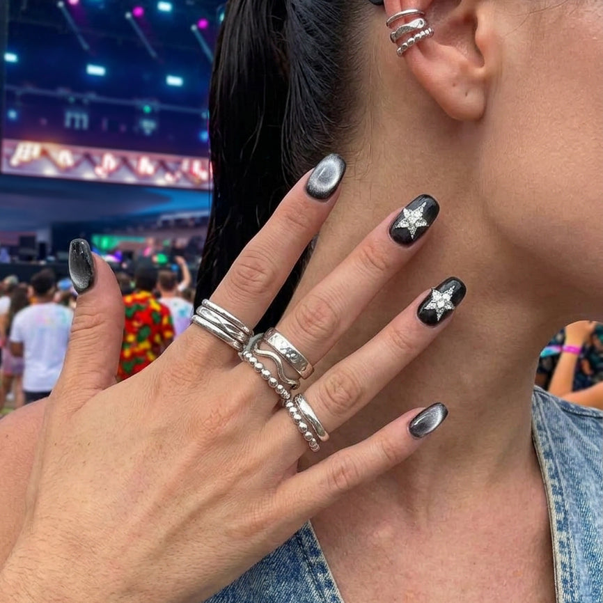 square nail art set with black and silver cat-eye designs, featuring star-shaped embellishments.