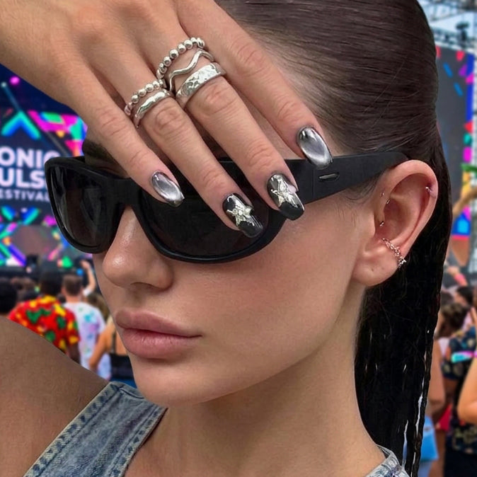 square nail art set with black and silver cat-eye designs, featuring star-shaped embellishments.