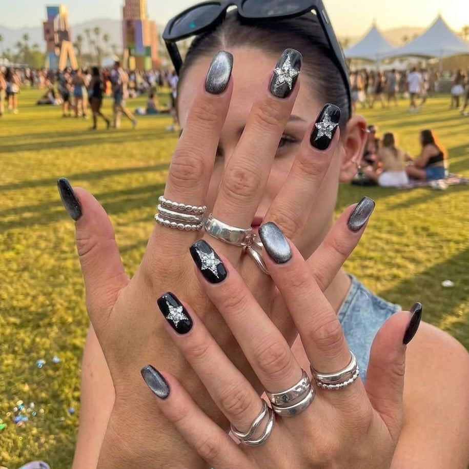 square nail art set with black and silver cat-eye designs, featuring star-shaped embellishments.
