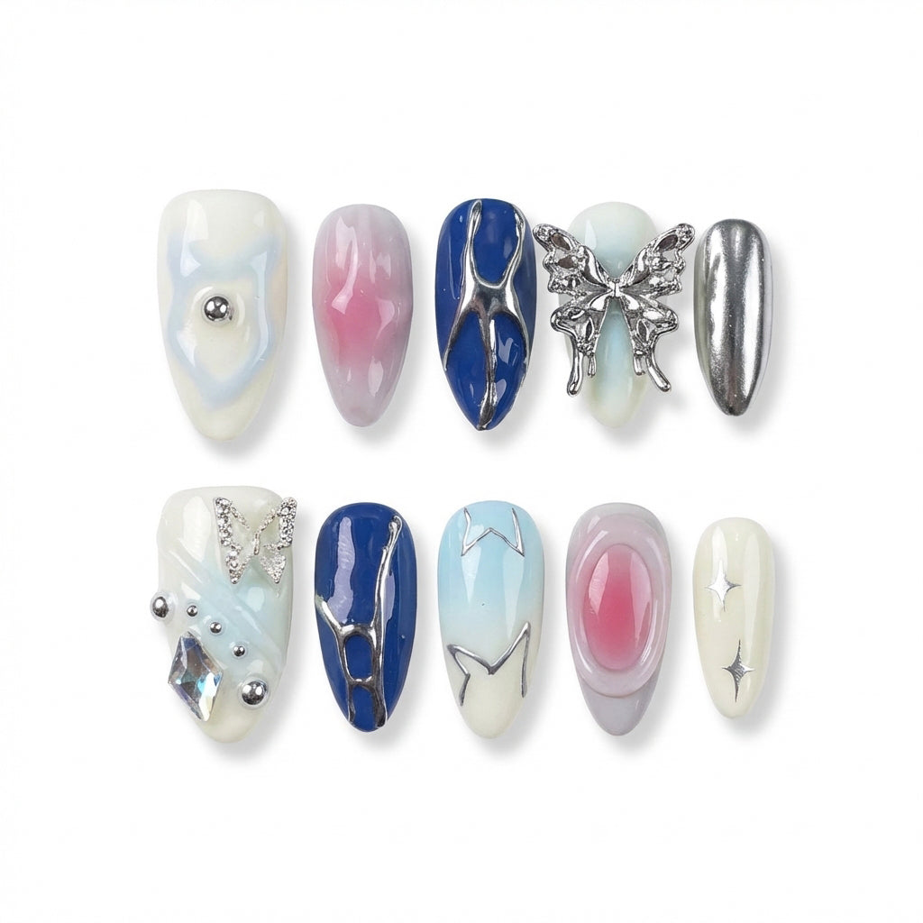 Ten decorative almond nail designs in various colors, featuring gems, a butterfly, and shiny accents.