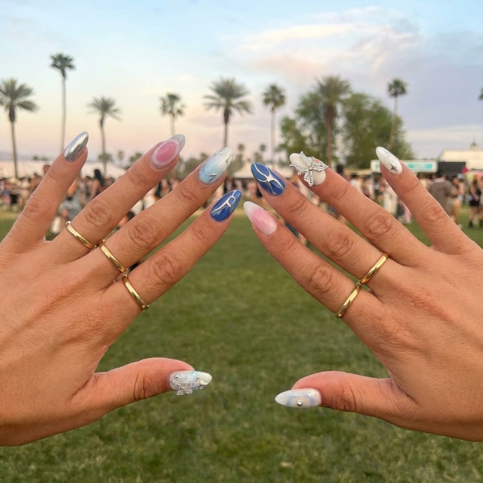 Ten decorative almond nail designs in various colors, featuring gems, a butterfly, and shiny accents.