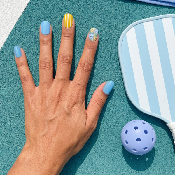 Azure Ace pickleball nails flat lay — cobalt blue short square press-ons with yellow floral | GlossyMuse