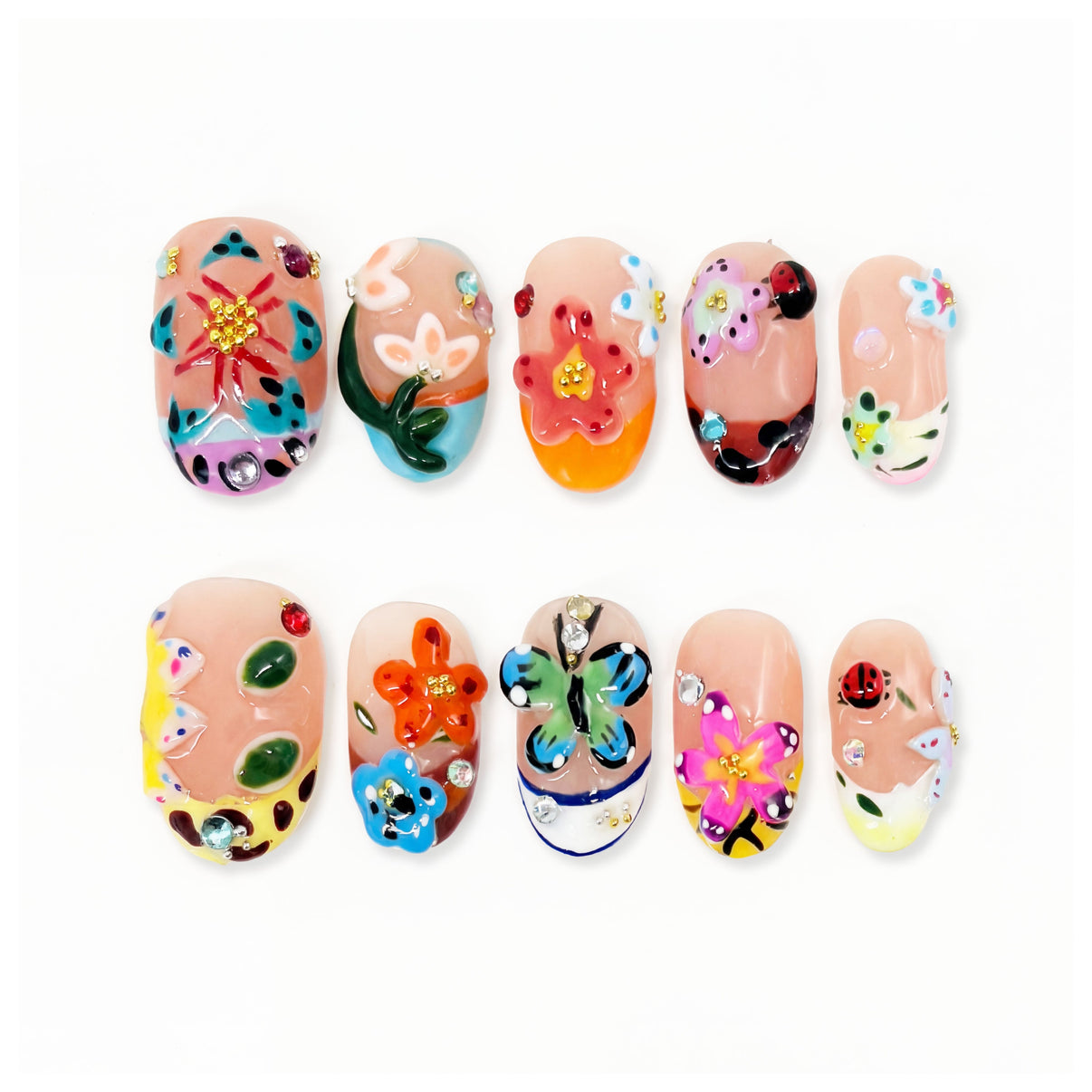 Colorful nail art set with flowers, butterflies, ladybug and gems on nude nails.