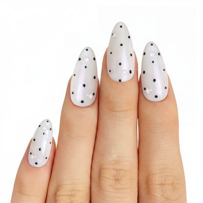 Model wearing Black & White Dot almond press-on nails — lifestyle close-up | GlossyMuse