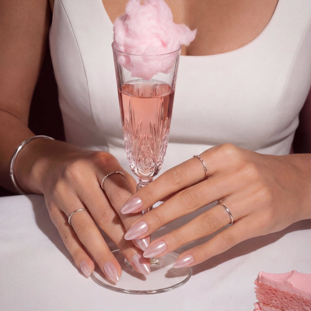 Model wearing Pink Champagne Spirtz almond press-on nails — lifestyle close-up | GlossyMuse