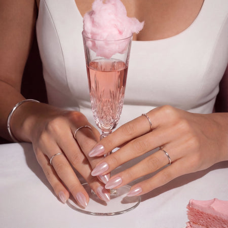 Model wearing Pink Champagne Spirtz almond press-on nails — lifestyle close-up | GlossyMuse