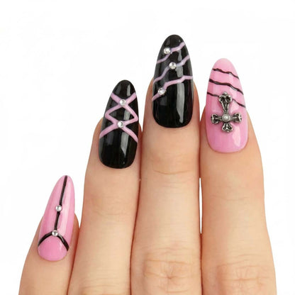 Model wearing Black Cross Honey almond press-on nails — lifestyle close-up | GlossyMuse